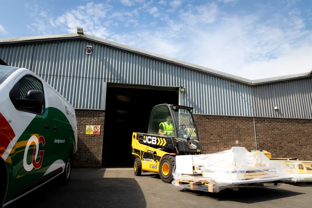 A JCB moving a pallete